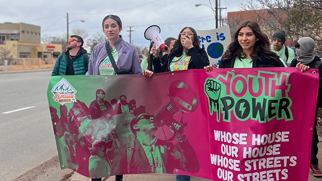 young climate leaders marching with youth power signs