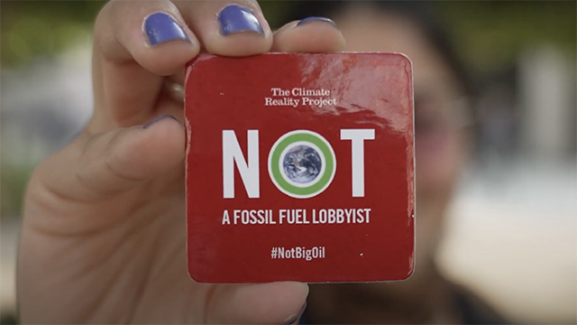 photo of a not a fossil fuel lobbyist sign