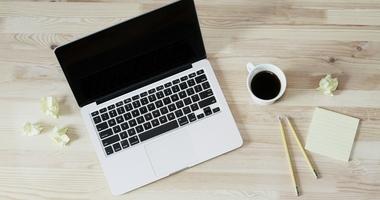 Computer with pencils and cup of coffee