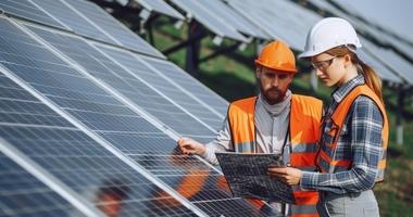 Woman and man inspecting solar panels