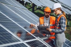 Woman and man inspecting solar panels