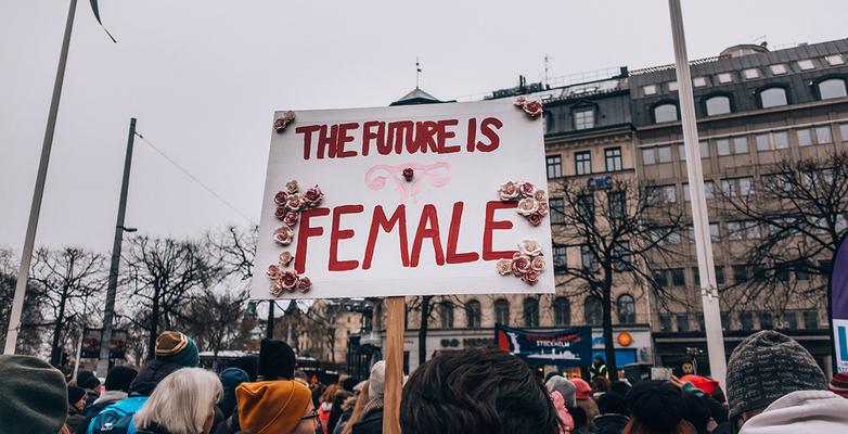 Rally with a sign that says The future is female